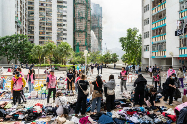 hong-kongchina-27th-november-2025-members-of-tai-po-disrict-care-team-and-volunteers-sort-out-the-donated-clothes-to-offer-help-to-those-in-need-after-a-fire-broke-out-at-the-wang-fuk-court-housing