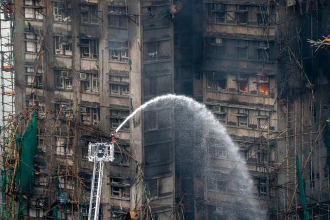 hong-kong-hong-kong-27th-nov-2025-a-firetruck-ladder-spraying-water-onto-a-building-as-a-major-fire-engulfs-several-residential-buildings-at-wang-fuk-court-on-november-27-2025-in-hong-kong-serva