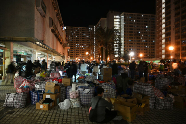 volunteers-passing-boxes-of-supplies-into-a-temporary-shelter-as-a-major-fire-engulfs-several-residential-buildings-at-wang-fuk-court-on-november-28-2025-in-hong-kong-serval-residential-building-in