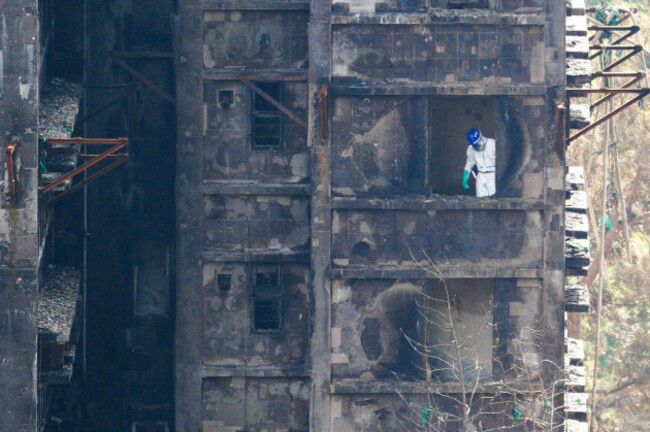hong-kong-hong-kong-02nd-dec-2025-a-police-officer-inside-one-of-the-burned-buildings-at-wang-fuk-court-housing-complex-in-tai-po-following-a-deadly-fire-on-december-2-2025-in-hong-kong-photo-b