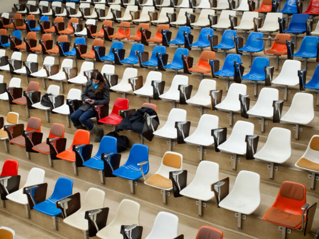 a-pretty-brunette-university-student-sits-in-an-empty-lecture-hall-at-the-university-of-alberta-in-edmonton-alberta-canada