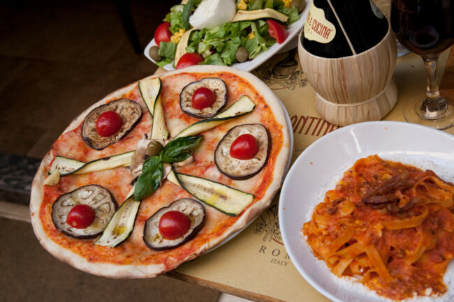 pizza-and-pasta-with-wine-on-table-in-restaurant-in-rome