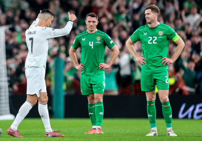 dara-oshea-and-nathan-collins-look-on-as-cristiano-ronaldo-leaves-the-pitch-after-a-red-card