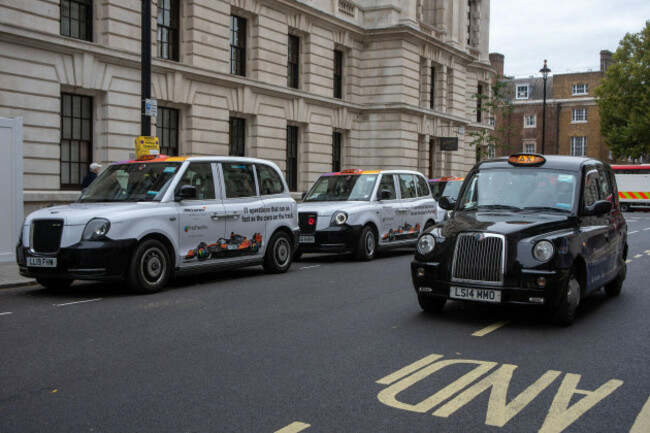 london-uk-18th-oct-2025-a-black-cab-drives-by-the-parked-vehicles-with-advertisements-on-them-near-the-whitehall-in-london-the-freshworks-is-a-leading-it-software-provider-company-the-recently-a