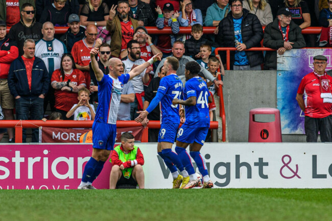 carlisle-uniteds-georgie-kelly-scores-his-sides-first-goal-of-the-game-and-celebrates-with-team-mates-during-the-sky-bet-league-2-match-between-morecambe-and-carlisle-united-at-the-mazuma-mobile-sta