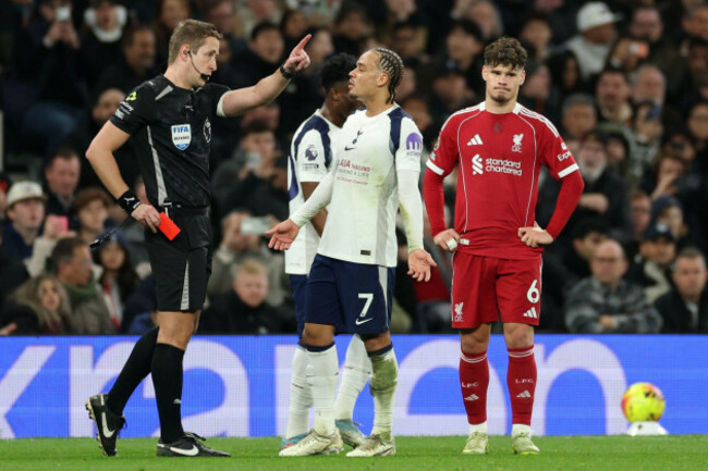 referee-john-brooks-left-shows-a-red-card-to-tottenhams-xavi-simons-center-during-the-english-premier-league-soccer-match-between-tottenham-and-liverpool-in-london-saturday-dec-20-2025-ap-p