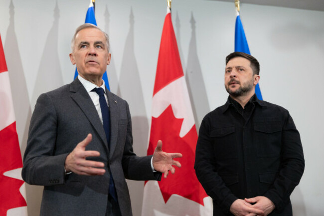 prime-minister-mark-carney-left-and-ukrainian-president-volodymyr-zelenskyy-hold-a-news-conference-in-halifax-n-s-on-saturday-dec-27-2025-riley-smith-the-canadian-press-via-ap