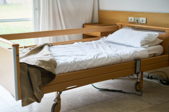 interior-of-nursing-home-with-blanket-and-pillow-on-empty-bed