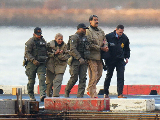 photo-by-xnystar-maxipx-2026-1526-nicolas-maduro-and-his-wife-cilia-flores-are-seen-in-handcuffs-after-landing-at-a-manhattan-helipad-escorted-by-heavily-armed-federal-agents-as-they-make-thei