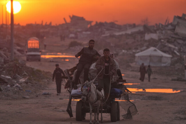 palestinians-walk-through-the-ruins-of-destroyed-buildings-as-the-sun-sets-over-gaza-city-sunday-jan-4-2026-ap-photojehad-alshrafi