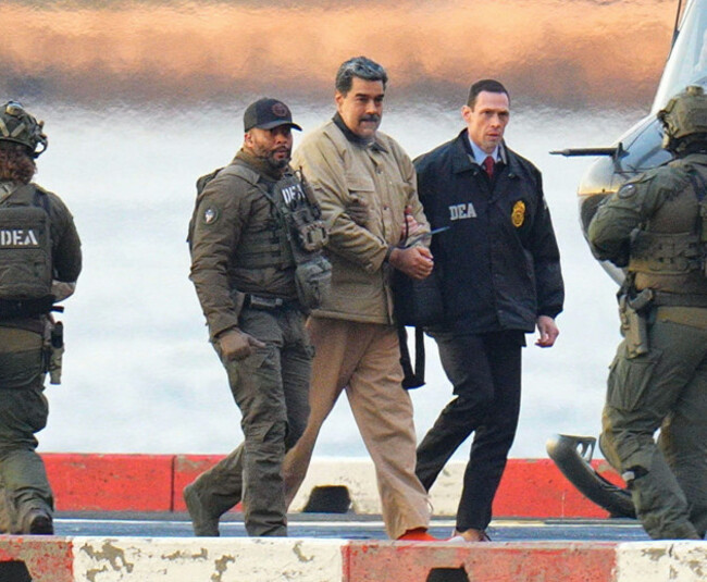 photo-by-xnystar-maxipx-2026-1526-nicolas-maduro-and-his-wife-cilia-flores-are-seen-in-handcuffs-after-landing-at-a-manhattan-helipad-escorted-by-heavily-armed-federal-agents-as-they-make-thei