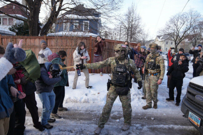 a-law-enforcement-agent-sprays-a-line-of-protestors-with-chemical-spray-scene-of-a-shooting-in-minneapolis-on-wednesday-jan-7-2026-alex-kormannstar-tribune-via-ap