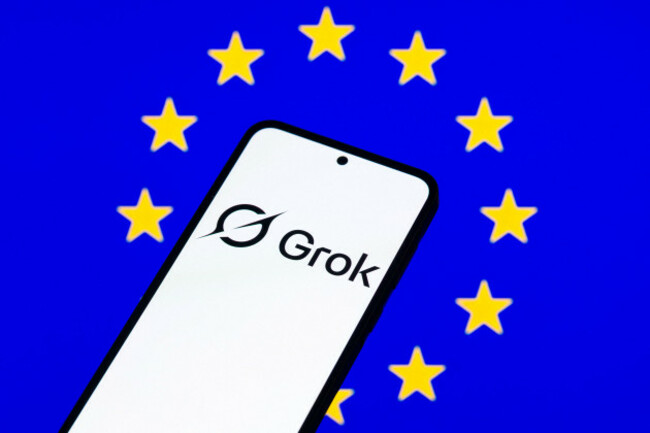 brussels-belgium-06th-jan-2026-the-grok-logo-is-displayed-on-a-mobile-phone-with-the-eu-flag-visible-seen-in-the-background-in-this-photo-illustration-taken-in-brussels-belgium-on-6-january-20