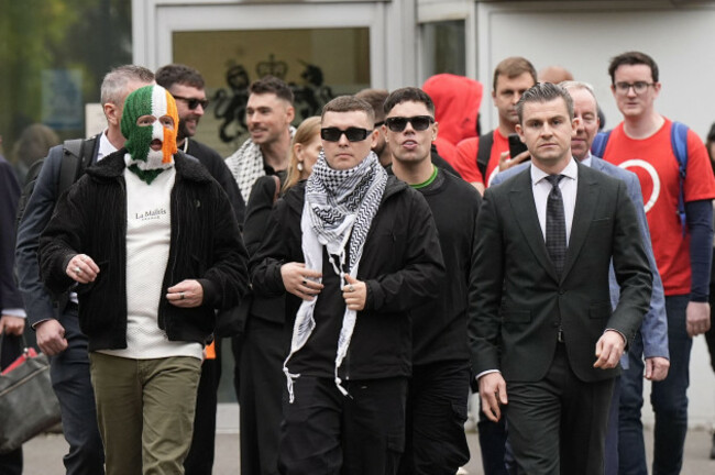file-photo-dated-26925-of-kneecaps-liam-og-o-hannaidh-centre-in-keffiyeh-with-his-lawyer-darragh-mackin-and-bandmates-jj-odochartaigh-left-and-naoise-o-caireallain-back-right-outside-wool