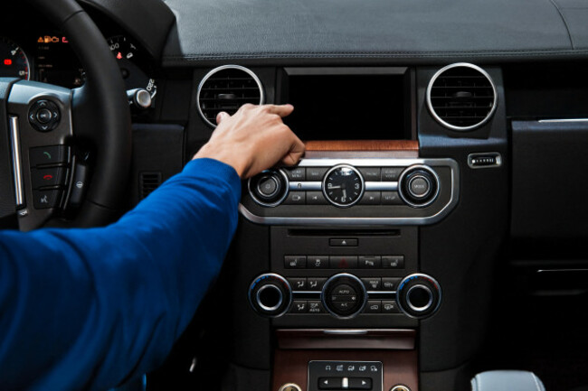 hand-using-car-audiodisplay