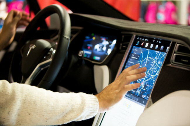helsinki-finland-november-04-2016-the-interior-of-a-tesla-model-x-electric-car-with-large-touch-screen-dashboard-hand-using-gps-navigation