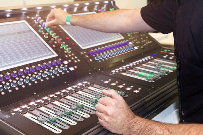 sound-engineer-hands-adjusting-control-sound-mixer-in-recording-broadcasting-studio