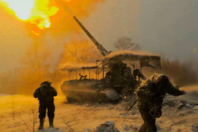 in-this-image-made-from-video-provided-by-russian-defense-ministry-press-service-on-tuesday-jan-13-2026-russian-soldiers-fire-a-pion-self-propelled-203-mm-gun-towards-ukrainian-positions-in-ukrain