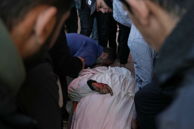 palestinians-mourn-over-the-body-of-mohammed-al-hawli-during-his-funeral-at-al-aqsa-hospital-in-deir-al-balah-central-gaza-strip-friday-jan-16-2026-after-he-was-killed-in-an-israeli-military-str