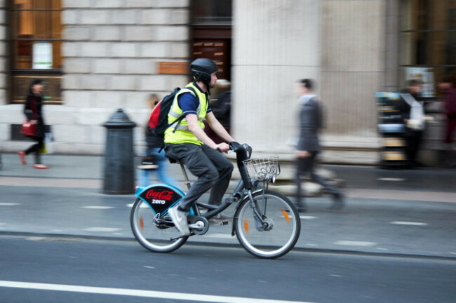 male-cyclist-cycling-along-oconnell-street-on-hired-citybike-dublin-republic-of-ireland-deliberate-motion-blur