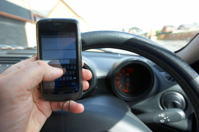 man-using-touchscreen-android-mobile-phone-to-send-a-text-message-when-driving