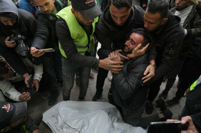 people-mourn-over-the-bodies-of-the-palestinian-journalists-abd-shaat-and-mohamed-qeshta-who-were-killed-in-an-israeli-strike-on-a-vehicle-before-their-funeral-at-shifa-hospital-in-gaza-city-wedne