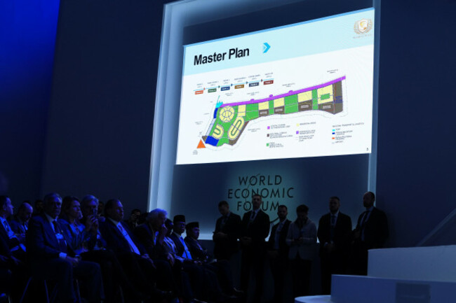 audience-members-view-a-presentation-on-a-large-screen-and-listen-to-speeches-after-the-signing-of-a-board-of-peace-charter-during-the-annual-meeting-of-the-world-economic-forum-in-davos-switzerland