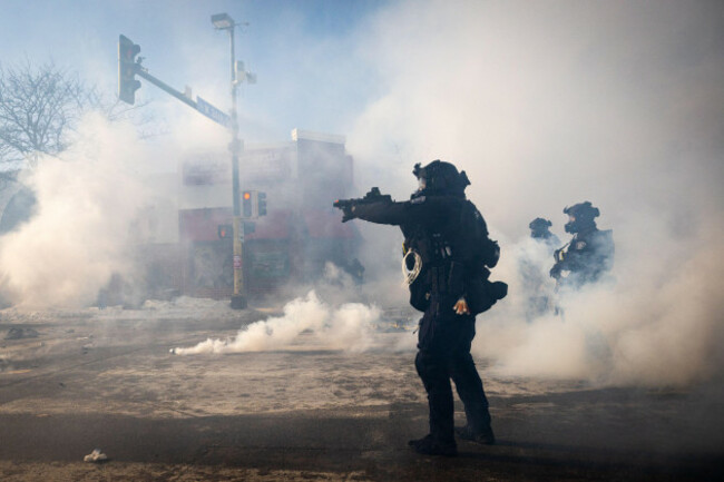 a-minneapolis-police-officer-aims-a-munition-launcher-amidst-a-thick-cloud-of-teargas-on-nicollet-avenue-in-minneapolis-on-saturday-jan-24-2026-ben-hovlandminnesota-public-radio-via-ap