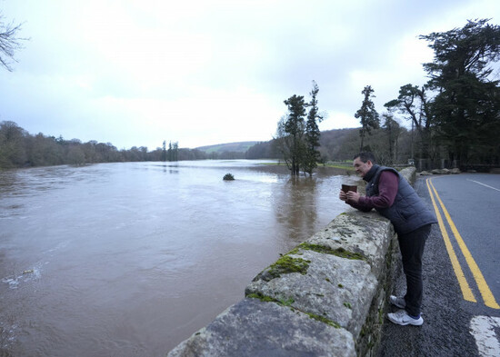 a-man-photographs-the-overflowing-river-slaney-in-bunclody-co-wexford-ireland-hundreds-of-schools-are-closed-and-tens-of-thousands-of-people-are-without-power-as-storm-chandra-batters-the-island