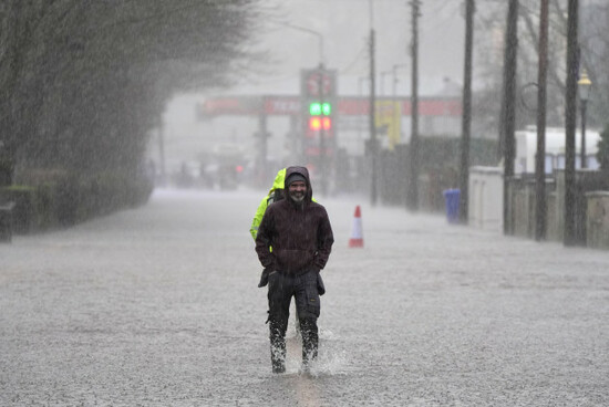 people-walking-through-flooded-roads-in-bunclody-co-wexford-hundreds-of-schools-are-closed-and-tens-of-thousands-of-people-are-without-power-as-storm-chandra-batters-the-island-of-ireland-picture