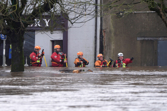 people-in-floodwaters-in-enniscorthy-co-wexford-hundreds-of-schools-are-closed-and-tens-of-thousands-of-people-are-without-power-as-storm-chandra-batters-the-island-of-ireland-picture-date-tuesd