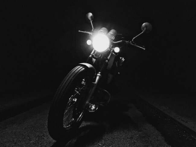 cyclops-black-and-white-photo-of-motorcycle-front-part-with-flashing-light-is-peeping-out-of-darkness-soro-denmark-5th-of-may-2017