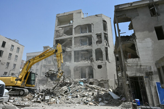 a-crane-clears-rubble-on-june-26-2025-at-a-building-in-tehran-destroyed-by-an-israeli-missile-strike-kyodokyodo-photo-via-credit-newscomalamy-live-news