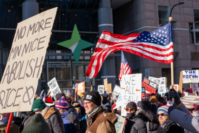 minneapolis-united-states-31st-jan-2026-protesters-carry-signs-and-flags-as-they-march-against-immigration-and-customs-enforcement-ice-it-is-the-second-general-strike-in-two-weeks-as-the-city-p