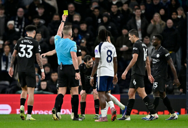 london-uk-1st-feb-2026-rob-jones-referee-shows-the-yellow-card-to-rodri-manchester-city-during-the-tottenham-hotspur-v-manchester-city-premier-league-match-at-the-tottenham-hotspur-stadium-lo