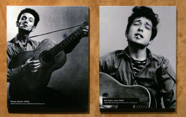 advance-for-weekend-editions-nov-20-21-a-photo-of-woody-guthrie-from-the-1940s-left-is-displayed-next-to-one-of-bob-dylan-from-the-1960s-as-part-of-a-new-display-about-dylan-at-the-exper