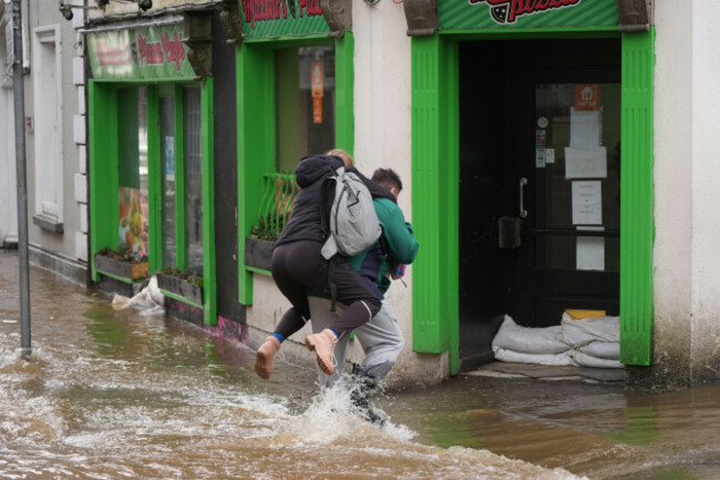 people-walking-through-floodwater-in-enniscorthy-co-wexford-hundreds-of-schools-are-closed-and-tens-of-thousands-of-people-are-without-power-as-storm-chandra-batters-the-island-of-ireland-picture