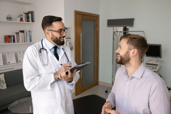 gp-asks-patient-about-condition-during-his-visit-at-clinic