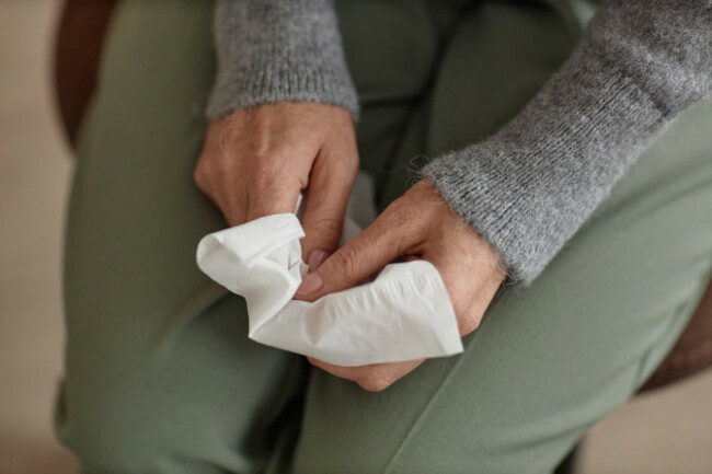 top-view-closeup-of-unrecognizable-senior-woman-holding-tissue-in-hands-during-therapy-session-and-crying-copy-space