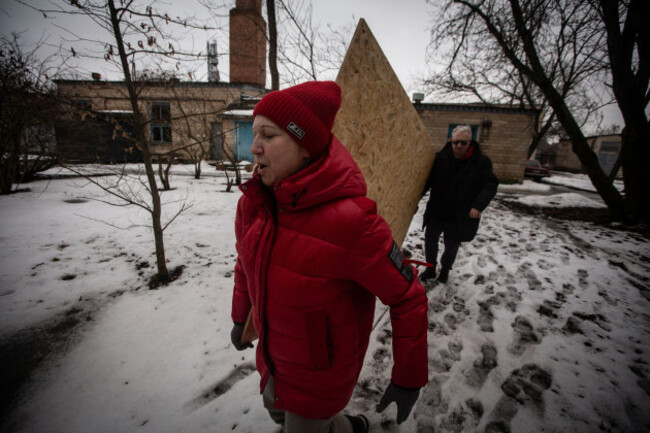 february-15-2026-sumy-sumy-ukraine-an-endocrinologist-and-a-surgeon-from-a-private-clinic-in-sumy-carry-a-wooden-board-to-cover-the-shattered-windows-of-their-center-after-a-russian-drone-attack