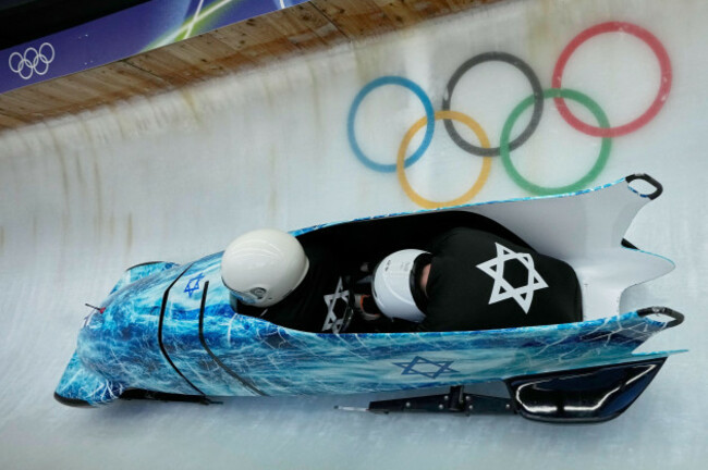 israels-adam-edelman-left-slides-down-the-track-during-a-two-man-bobsled-training-session-at-the-2026-winter-olympics-in-cortina-dampezzo-italy-friday-feb-13-2026-ap-photoaijaz-rahi