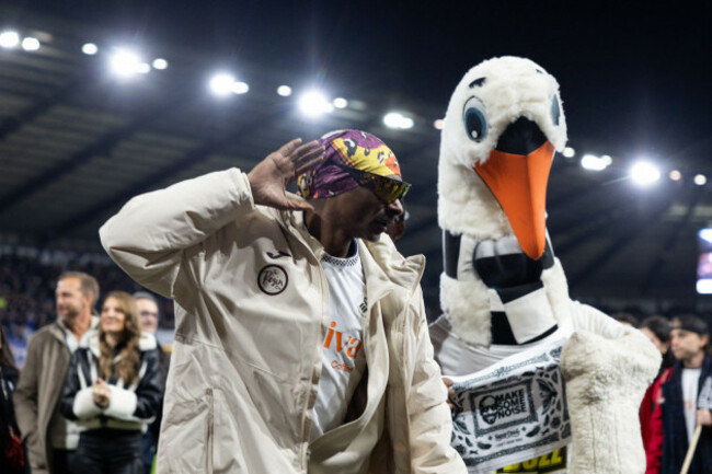swansea-uk-24th-feb-2026-snoop-dogg-the-american-rapper-co-owner-of-swansea-city-afc-is-seen-with-swansea-city-club-mascot-cyril-the-swan-ahead-of-the-efl-skybet-championship-match-swansea-city