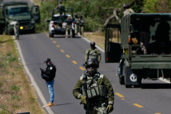 a-soldier-clears-a-roadblock-on-a-road-leading-to-tapalpa-mexico-monday-feb-23-2026-a-day-after-the-mexican-army-killed-jalisco-new-generation-cartel-leader-nemesio-oseguera-cervantes-known-as