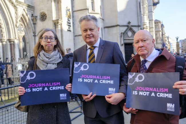 Vincent Kearney, Laura Davison and S&eacute;amus Dooley holding 'Journalism Is Not A Crime' signs outside the Royal Courts of Justice