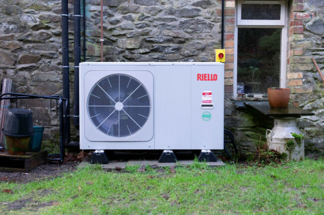 riello-air-source-heat-pump-on-the-back-wall-of-a-stone-house-cottage-in-carmarthenshire-wales-uk-great-britain-2025-kathy-dewitt