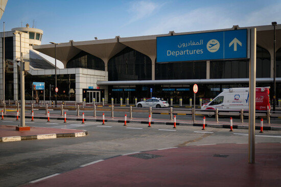 a-police-vehicle-and-an-ambulance-are-parked-on-the-departure-road-of-the-dubai-international-airport-as-it-lies-deserted-following-its-closure-in-dubai-united-arab-emirates-sunday-march-1-2026