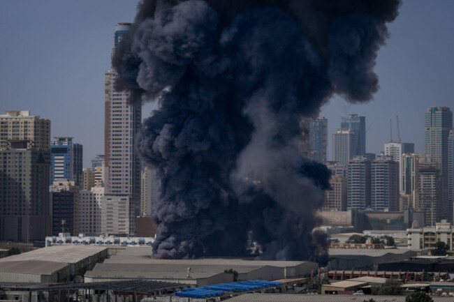 a-black-plume-of-smoke-rises-from-a-warehouse-at-the-industrial-area-of-sharjah-city-in-the-united-arab-emirates-following-reports-of-iranian-strikes-in-dubai-united-arab-emirates-sunday-march-1-2