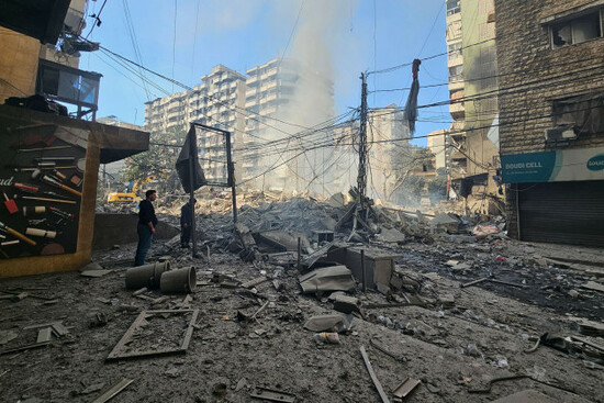 residents-stand-near-debris-at-the-site-of-a-building-hit-in-an-israeli-airstrike-on-dahiyeh-a-southern-suburb-of-beirut-lebanon-tuesday-march-3-2026-ap-photohassan-ammar