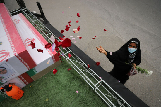 a-woman-throws-rose-petals-on-the-coffins-during-funeral-of-mostly-children-killed-in-what-iranian-officials-said-was-an-israeli-u-s-strike-feb-28-on-a-girls-elementary-school-in-minab-iran-tuesd