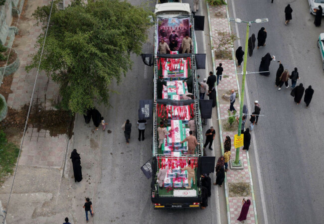 this-picture-released-by-the-iranian-governments-foreign-media-department-and-distributed-by-the-ap-without-changes-shows-coffins-being-carried-before-a-funeral-procession-for-the-victims-mostly-c